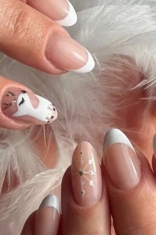 White French Nails with Snowflake and Feather, fun winter nail idea for women over 60