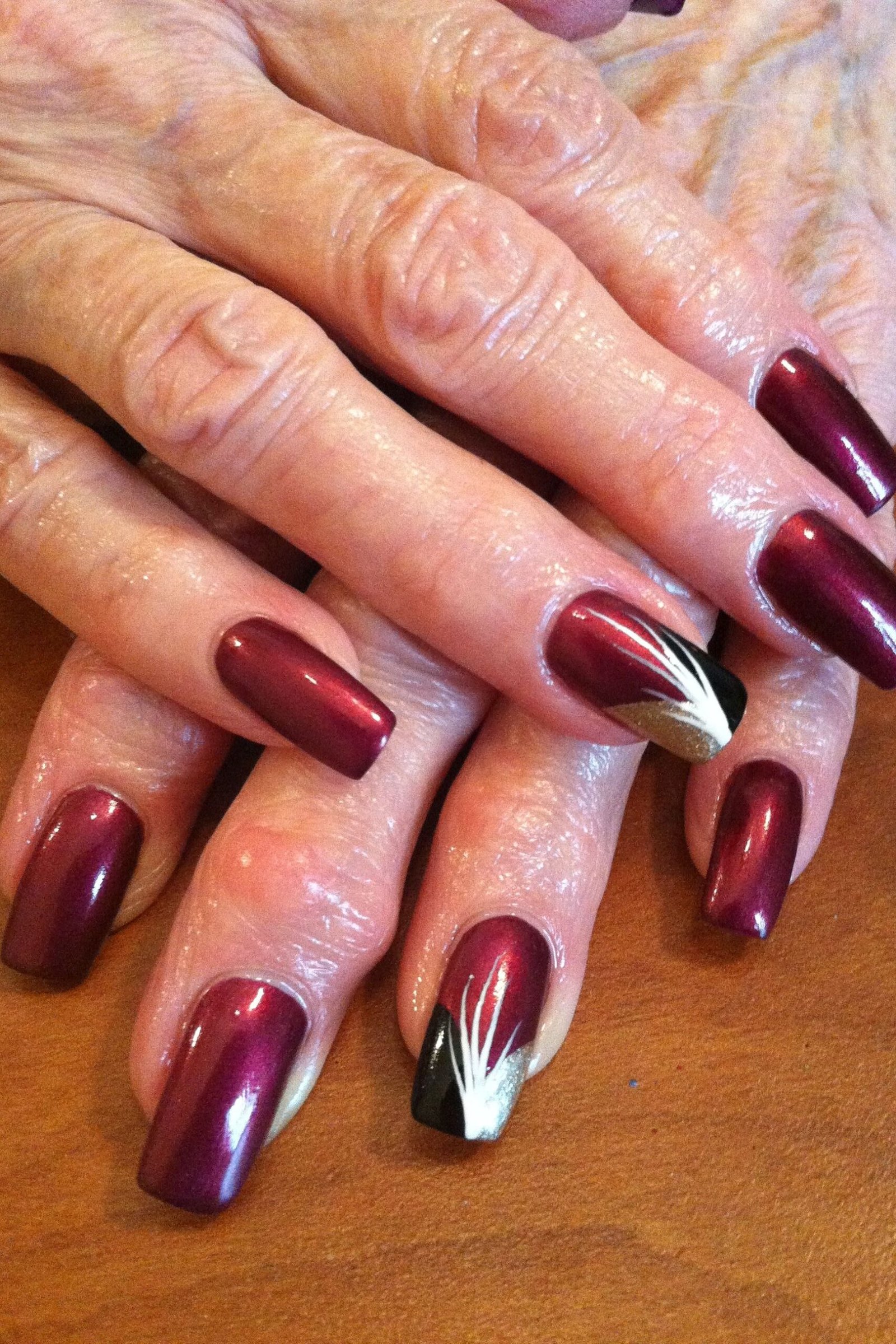 burgundy nails with brushstroke nail art