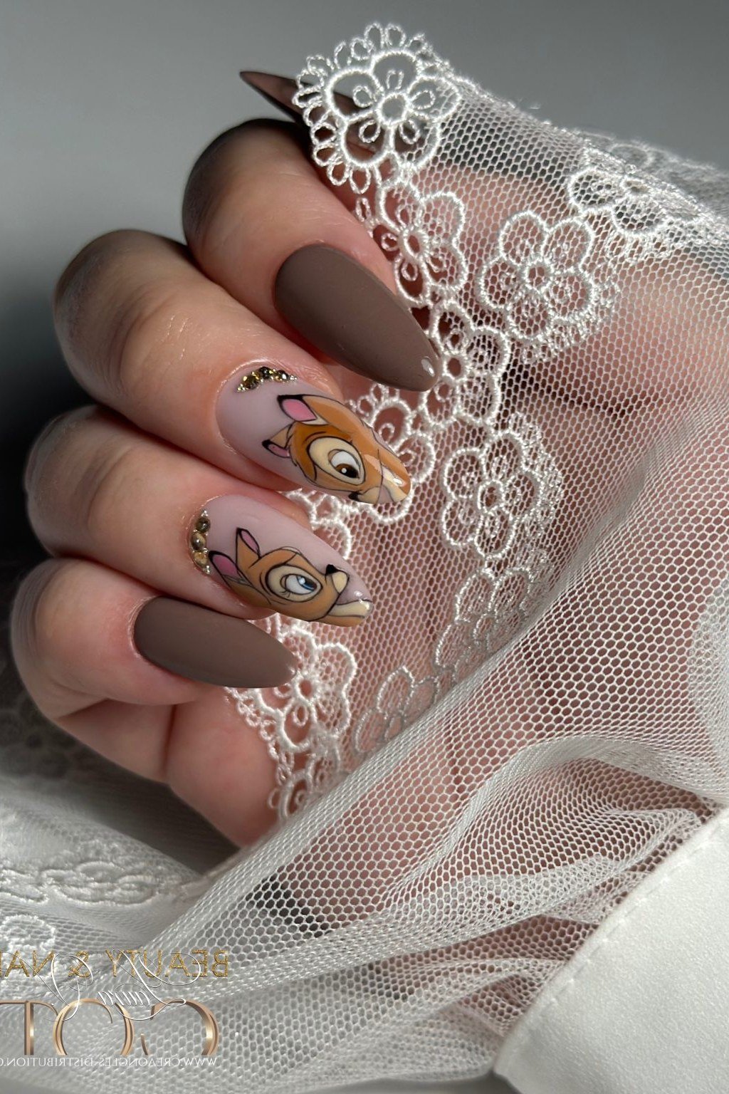 Taupe and nude almond nails with Bambi portrait accents for older women