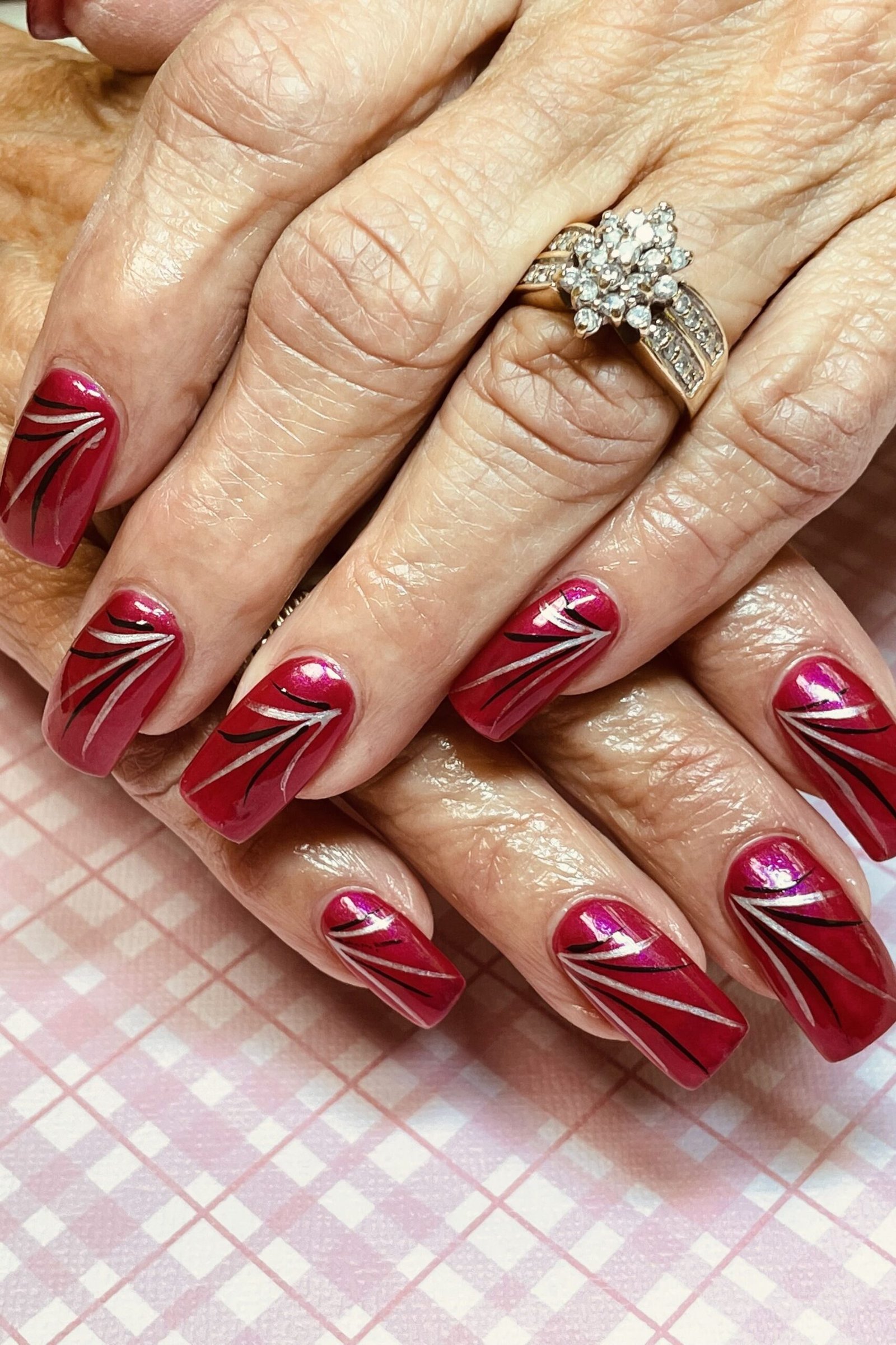 Red Manicure with White Swirl Art for women over 60