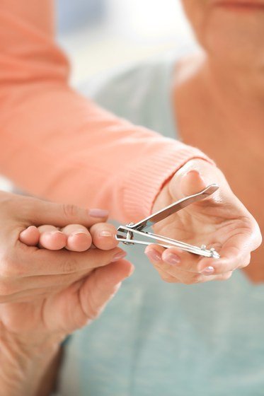 Trimming mature nails straight across with nail clippers
