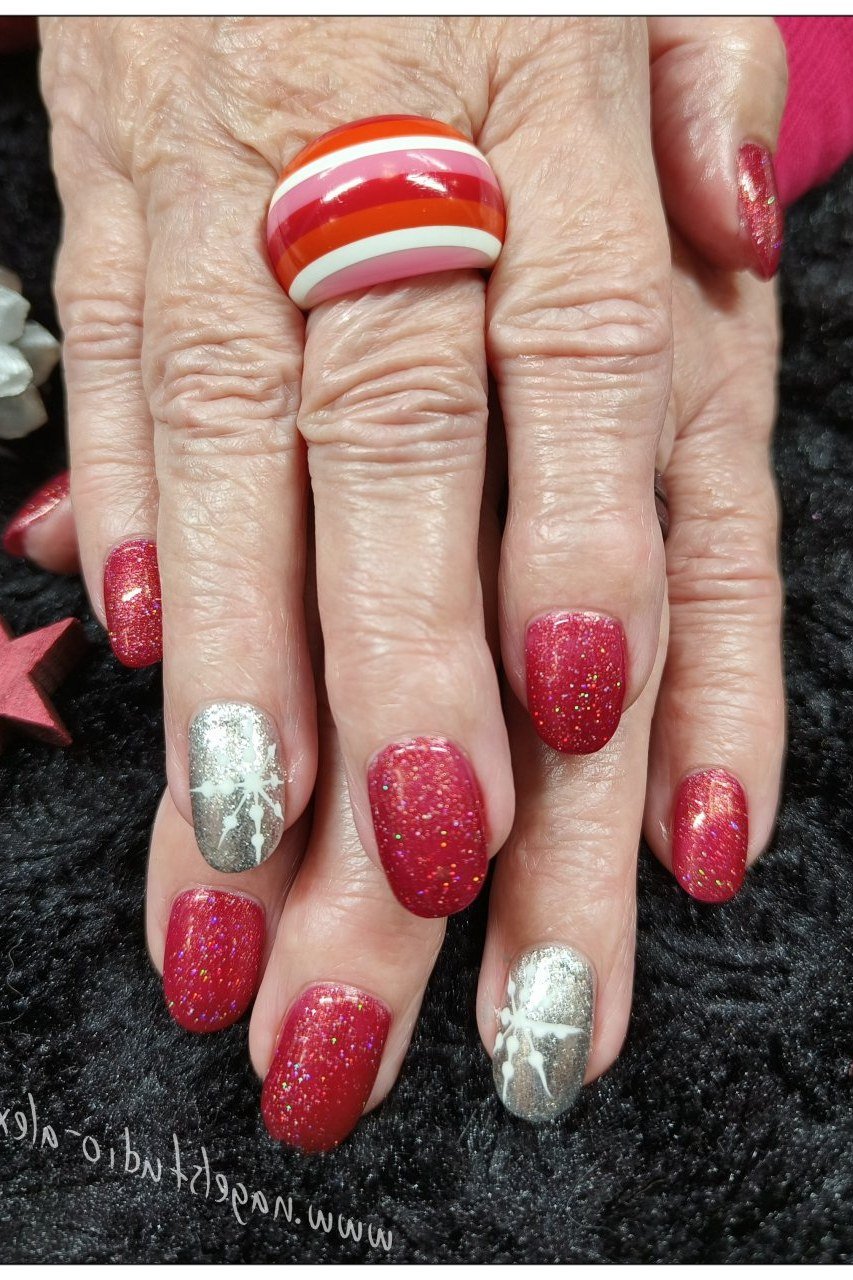 Red glitter nails with silver accent nails, mature hand - Christmas nail design for older women