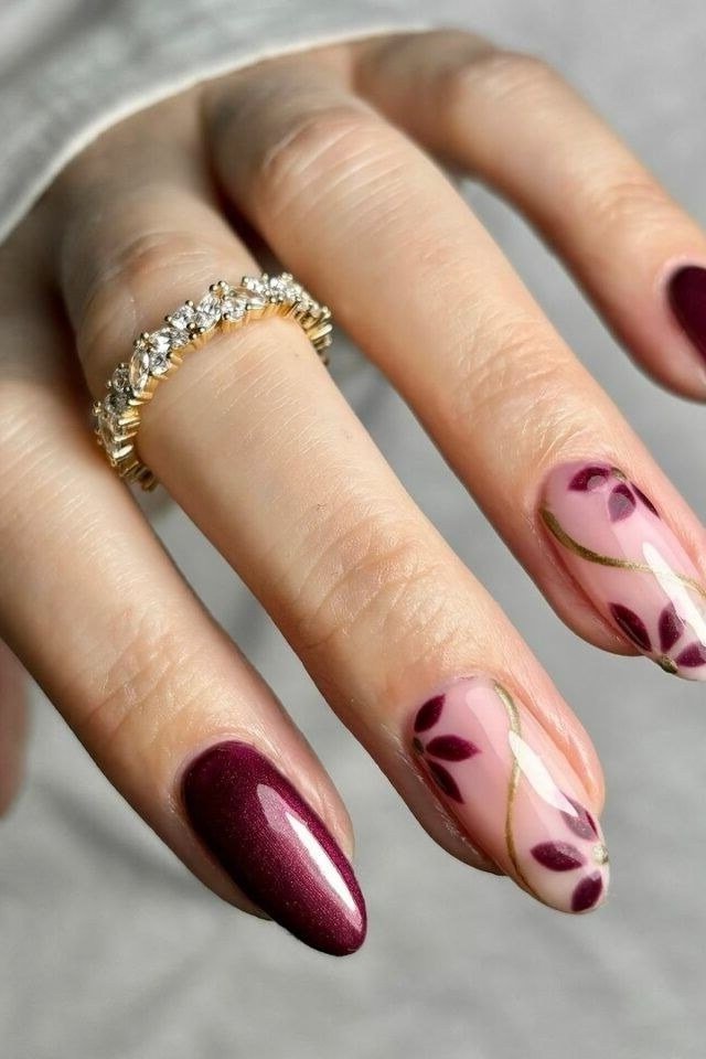 Burgundy marble nails with gold leaf accent for women over 50