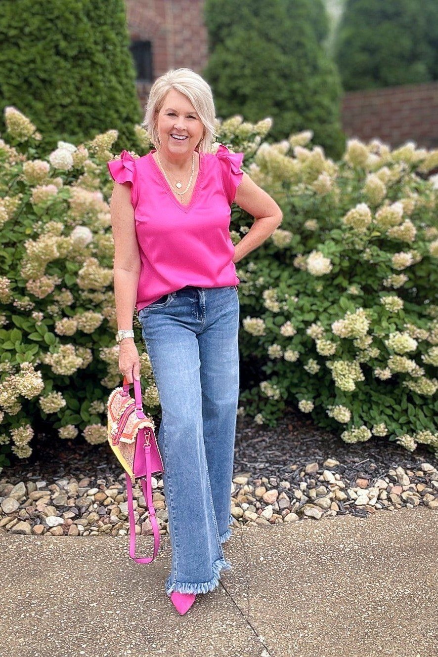 hot pink ruffle sleeve top medium wash jeans pink heels women over 50