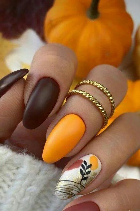 6. Matte Brown and Bright Orange Pumpkin Nails - Thanksgiving nail art idea for women over 50