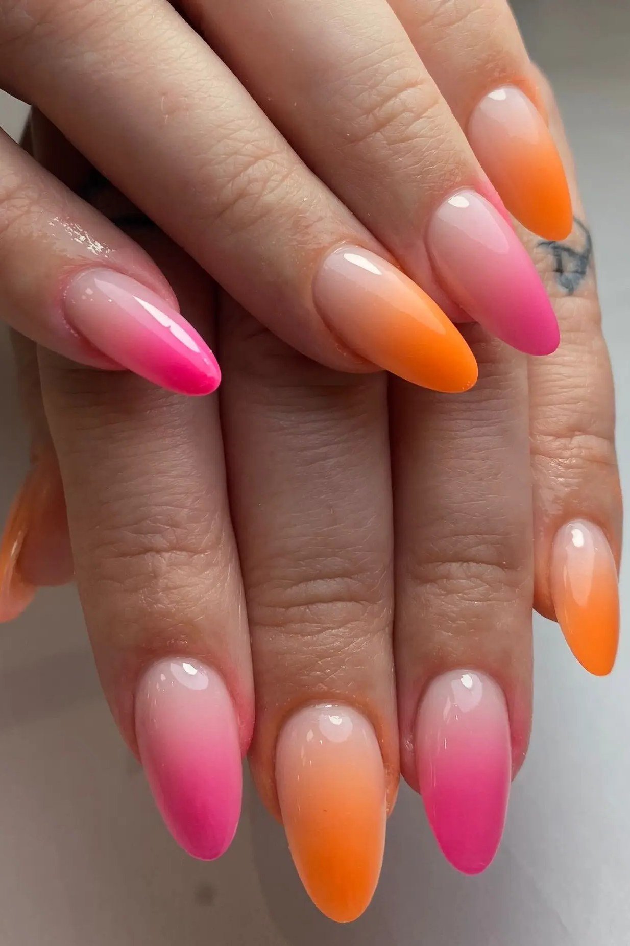 Neon Pink Orange Long Almond Nails - Electric pink and tangerine take turns across these long almond nails in a bold ombre fade.