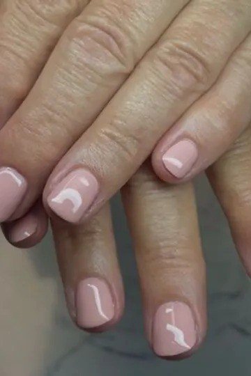 Glossy baby pink short nails for women over 50