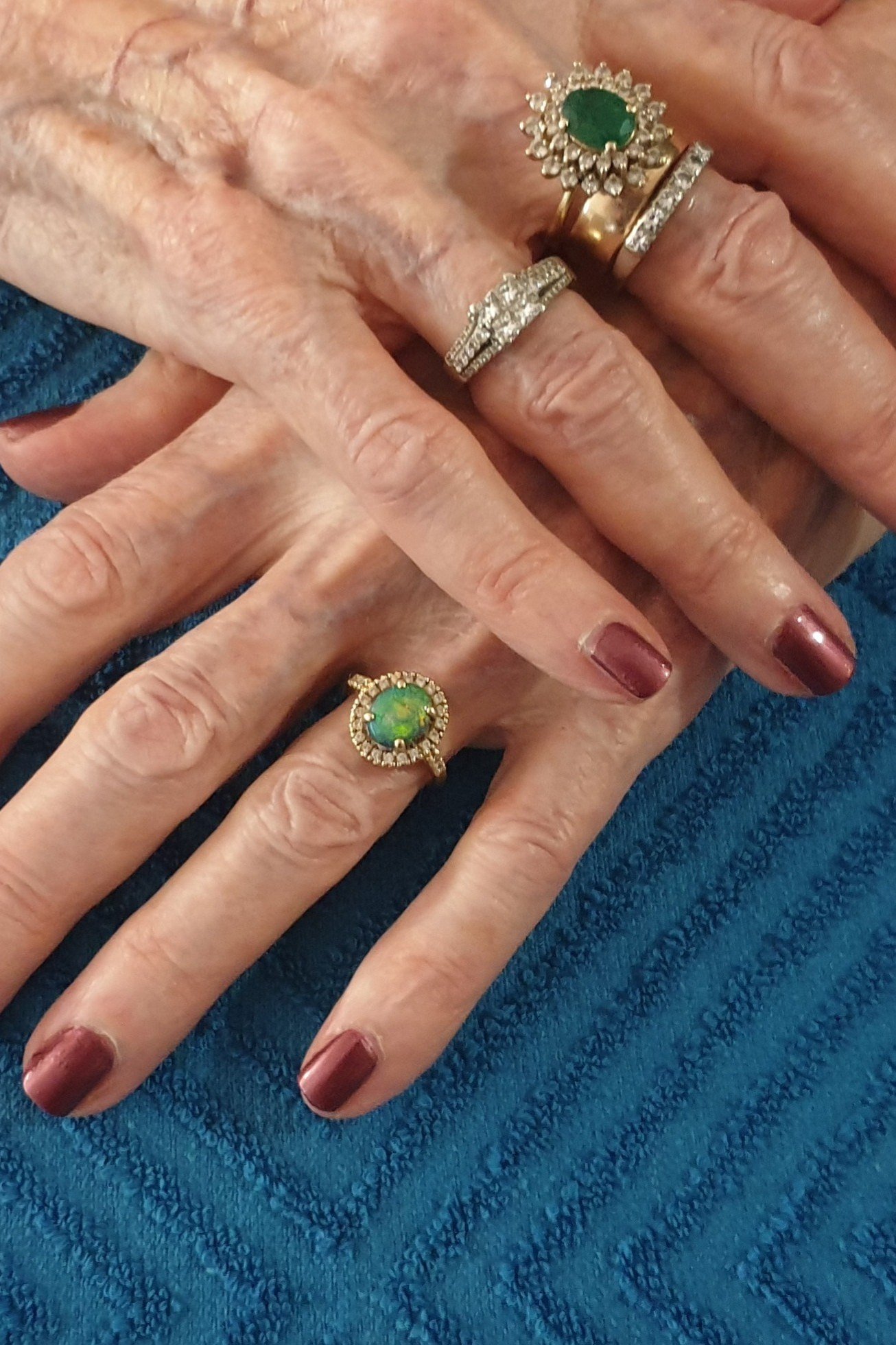 berry polish, green gemstone ring, teal towel - winter nail trend for older women
