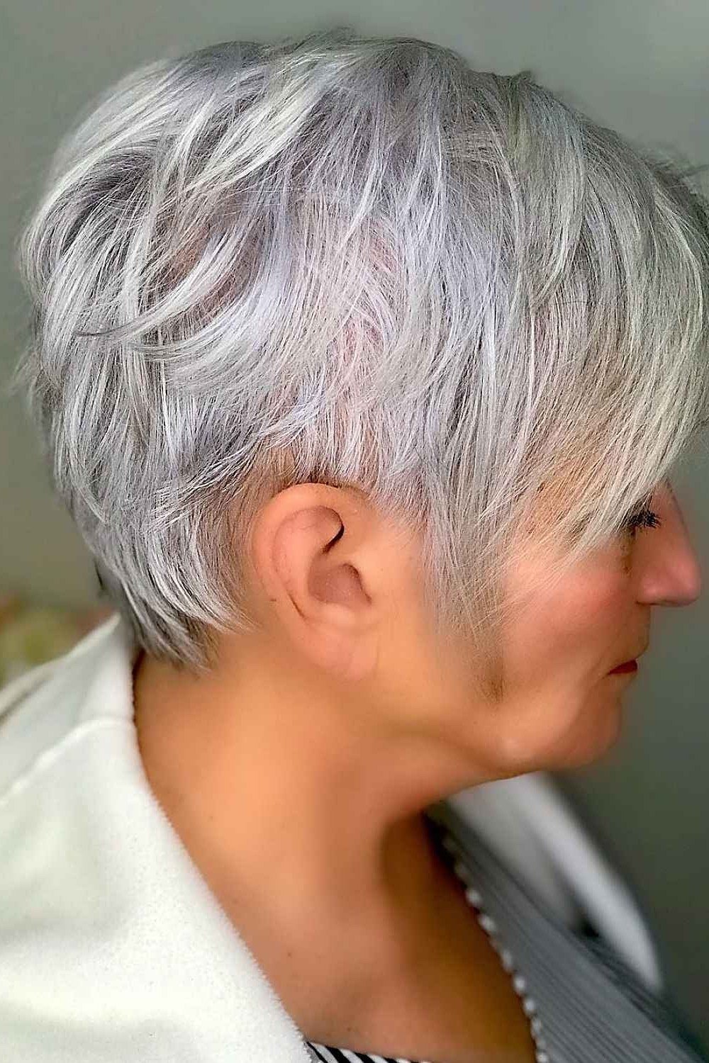 Silver layered pixie, feathered sides, side view for women over 60