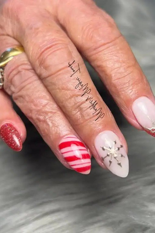 Red glitter nails with white/pink striped accent nail - Christmas nail design for older women