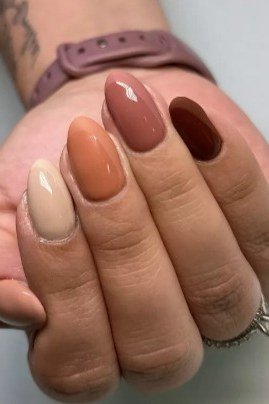 Warm brown gradient nails on mature hand, fall nail design for older women