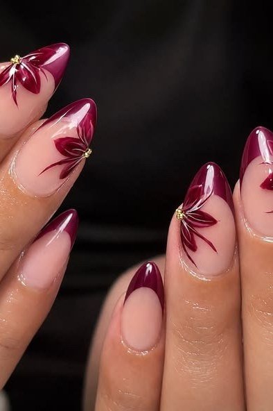 Burgundy french tip nails with floral accent for women over 50