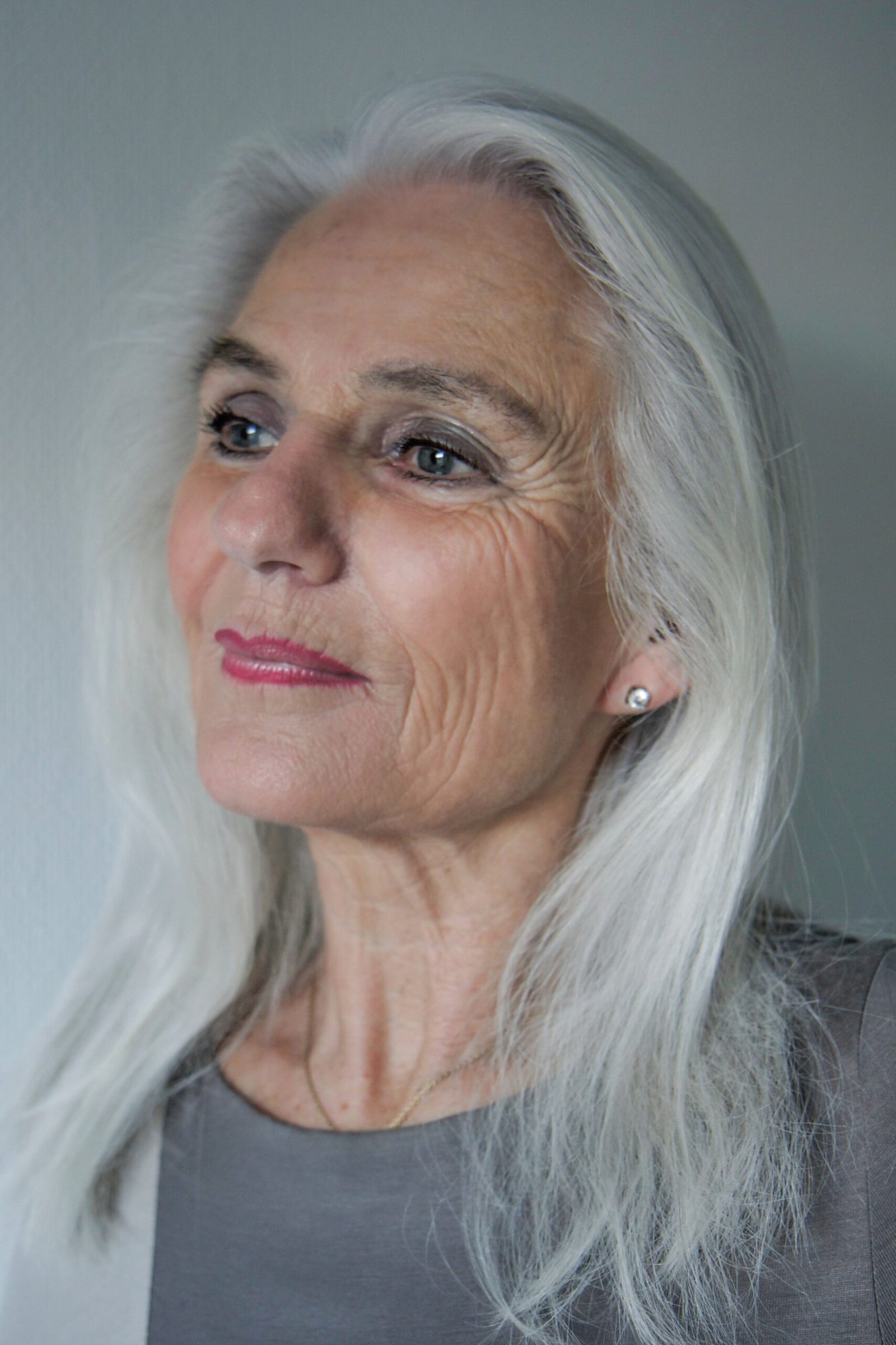 long straight silver hair on woman over 60, front view
