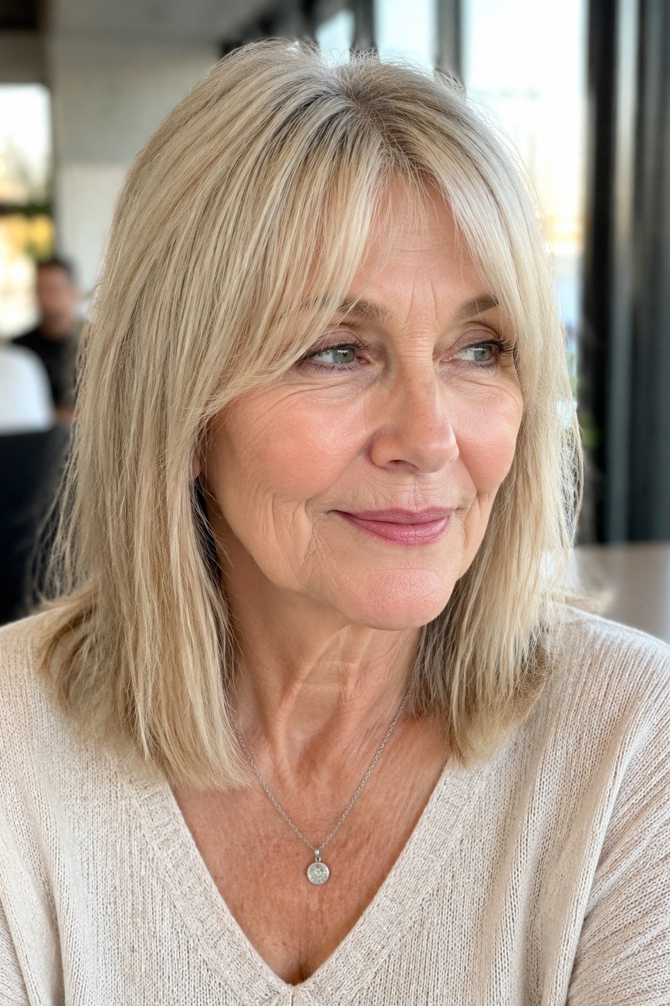 Blonde lob with curtain bangs, front view, woman in her 60s