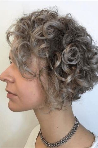 Salt and pepper curly bixie haircut side view for women over 60