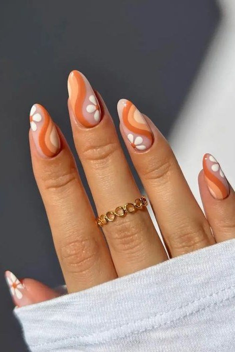 7. Peach Swirl Nails With Daisy Accents - Thanksgiving nail art idea for women over 50