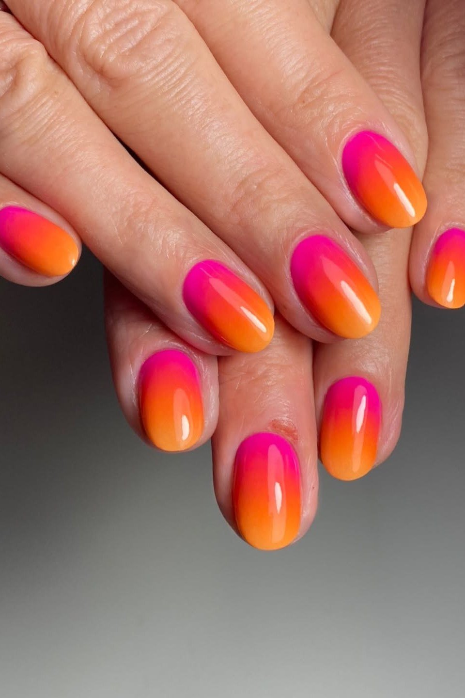 Pink Orange Sunset Rounded Nails - Soft pink fades into peachy orange on these medium rounded nails.