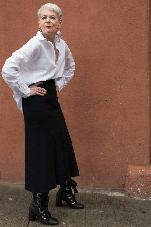 white shirt with long black skirt and ankle boots, chic outfit for women over 50
