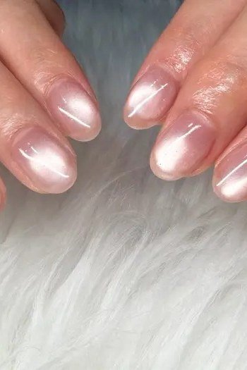 short oval, chrome pink shimmer, two hands on white fur , for women over 60