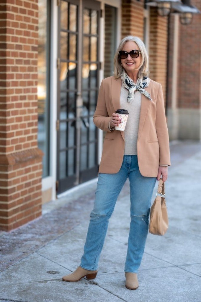Camel blazer with white top and light wash jeans for women over 60