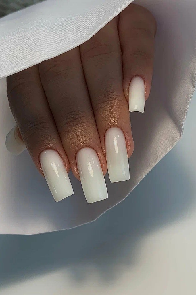 Classic short square nails in sheer milky white polish