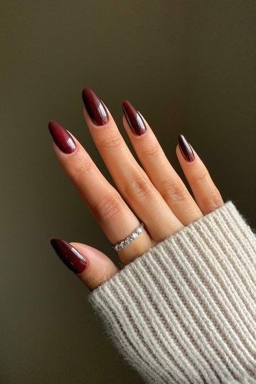 Glossy burgundy almond on sweater, burgundy fall nail idea for women over 60