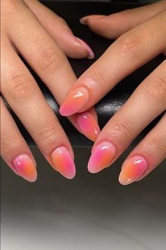 Bright Pink to Orange Short Oval Nails - Hot pink at the cuticle melts into bright orange tips on these short oval nails.