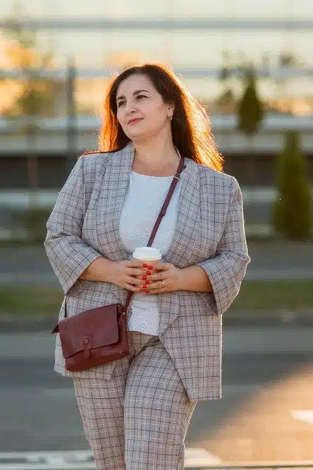 Work outfit for women over 40: gray plaid suit with burgundy crossbody bag