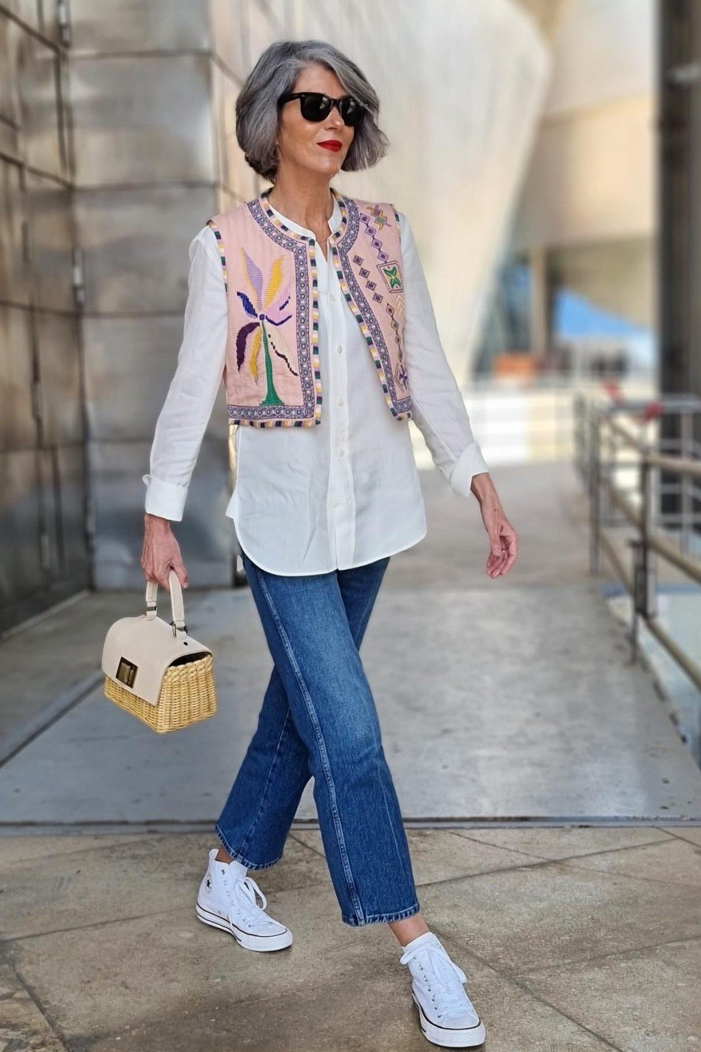 Casual fall outfit for women over 60: forest green sweater, charcoal trousers, brown ankle boots