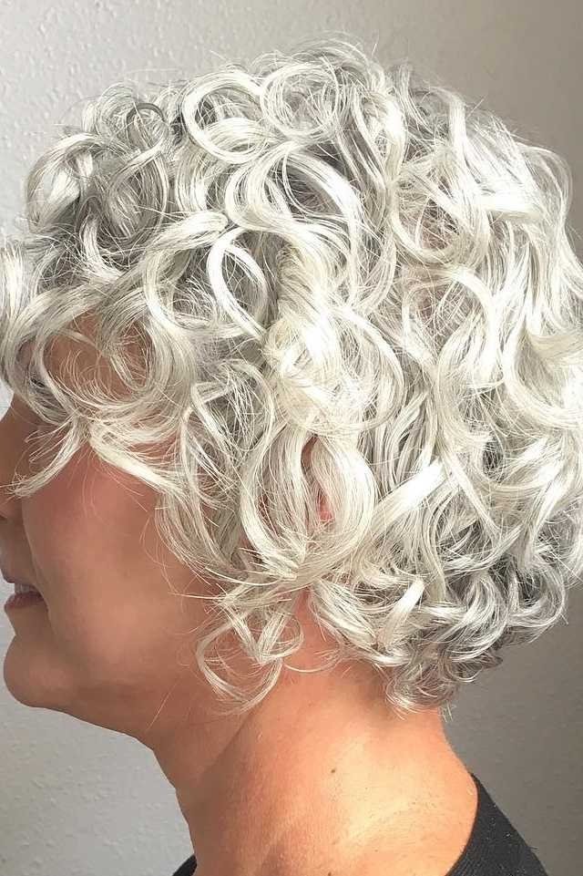 Crisp white curly bob haircut for mature women
