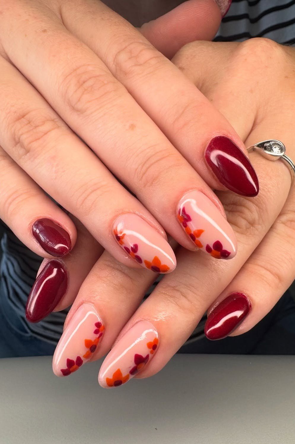 Red burgundy nails with floral accent nails for women over 50