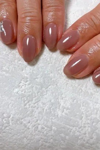 Nude glossy nails closeup, best manicure idea for women over 60