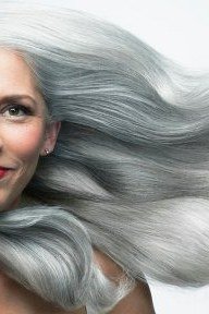 windblown long silver waves on mature woman with red lips