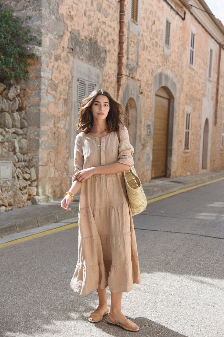 Sand tiered maxi dress, street with stone wall for women over 60