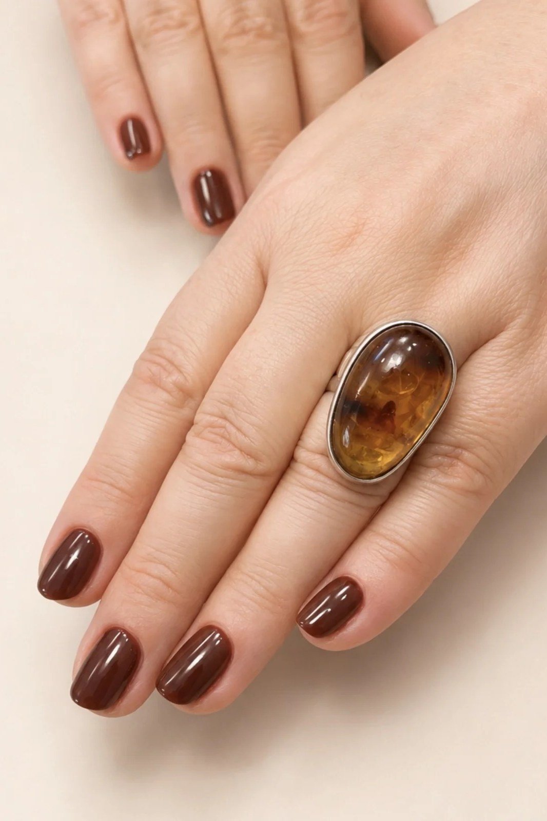 Oxblood Short Oval Nails with an Amber Ring - old money fall nail color for women over 40