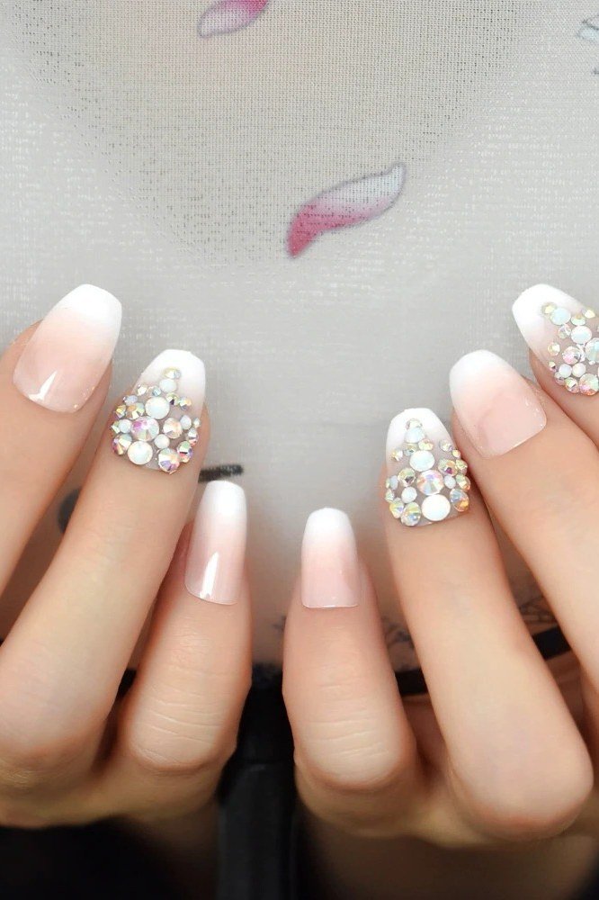 pink white baby boomer fade with rhinestones on almond nails