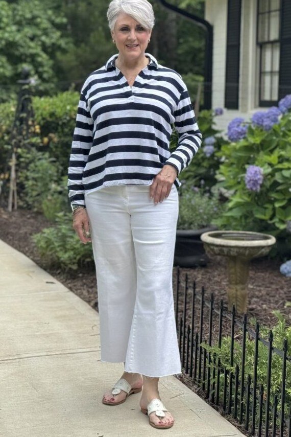 Woman over 50 wearing striped pullover with white pants, everyday casual outfit idea