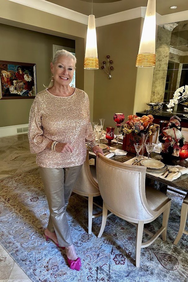 holiday evening outfit for women over 60: champagne sequin top with grey pants