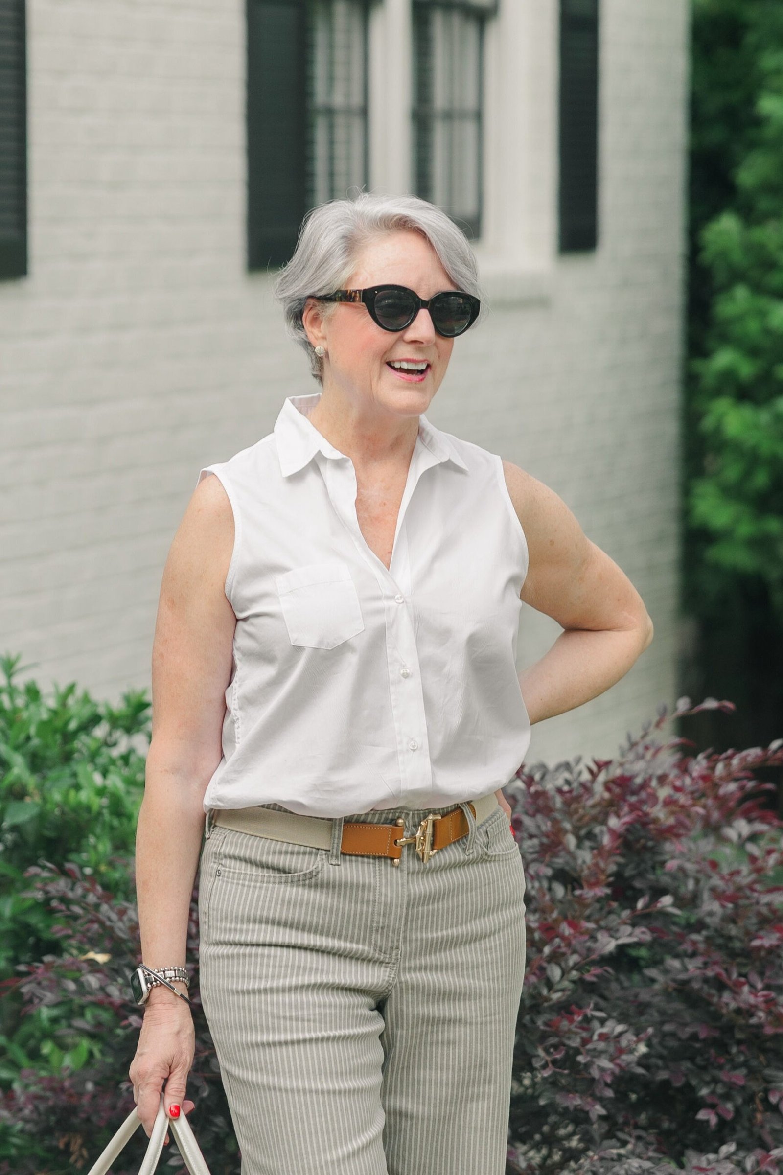 white sleeveless shirt sage trousers women over 50