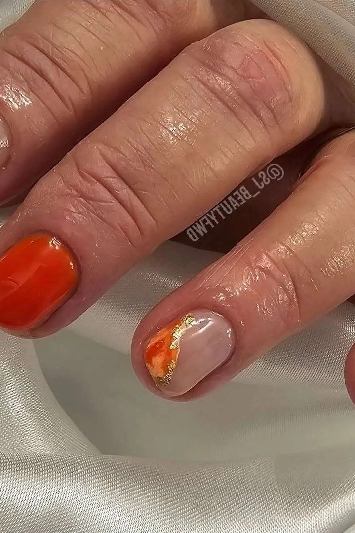 Bright Orange Nails with a Gold Foil Accent, fall nail color idea for women over 50