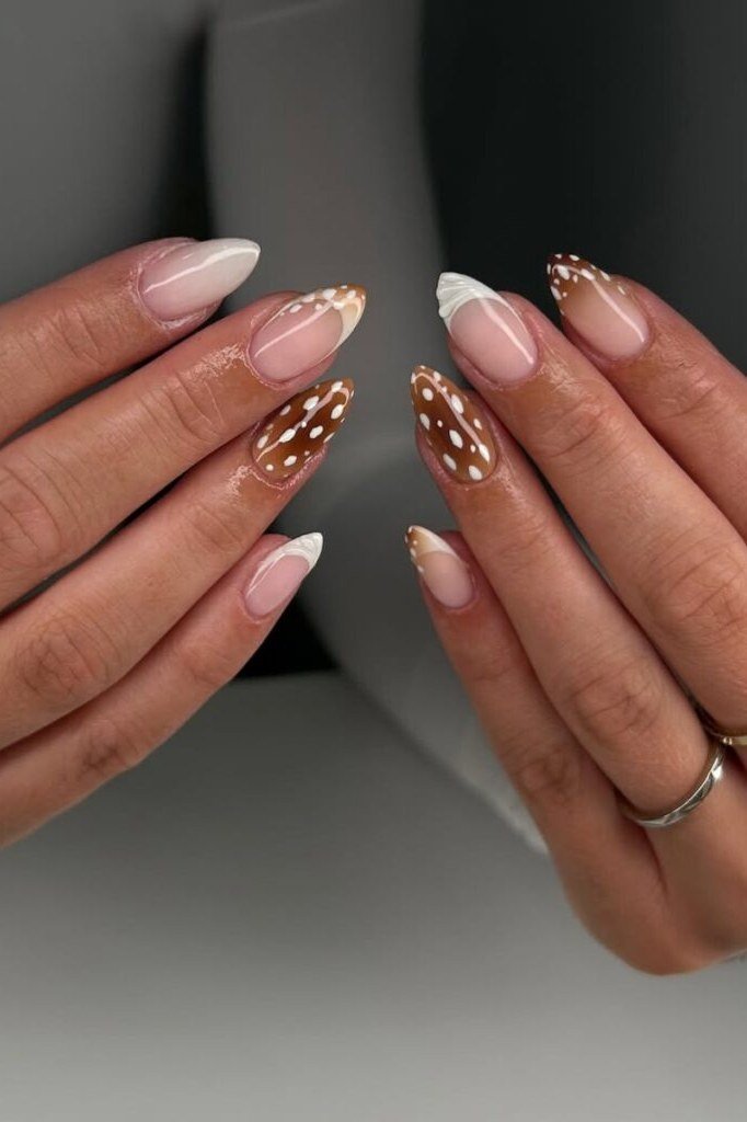 Nude almond nails with white fawn spots on caramel gradient tips