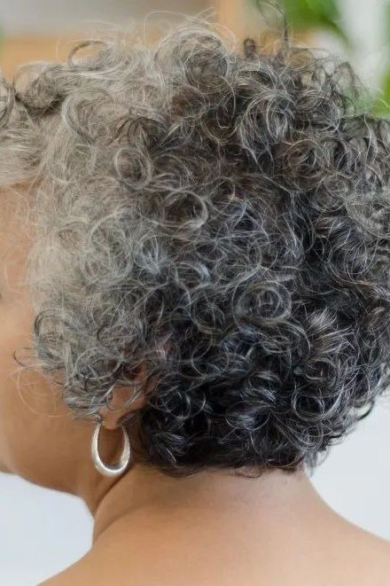 Side-Swept Dark Curly Pixie - short curly hairstyle for women over 60