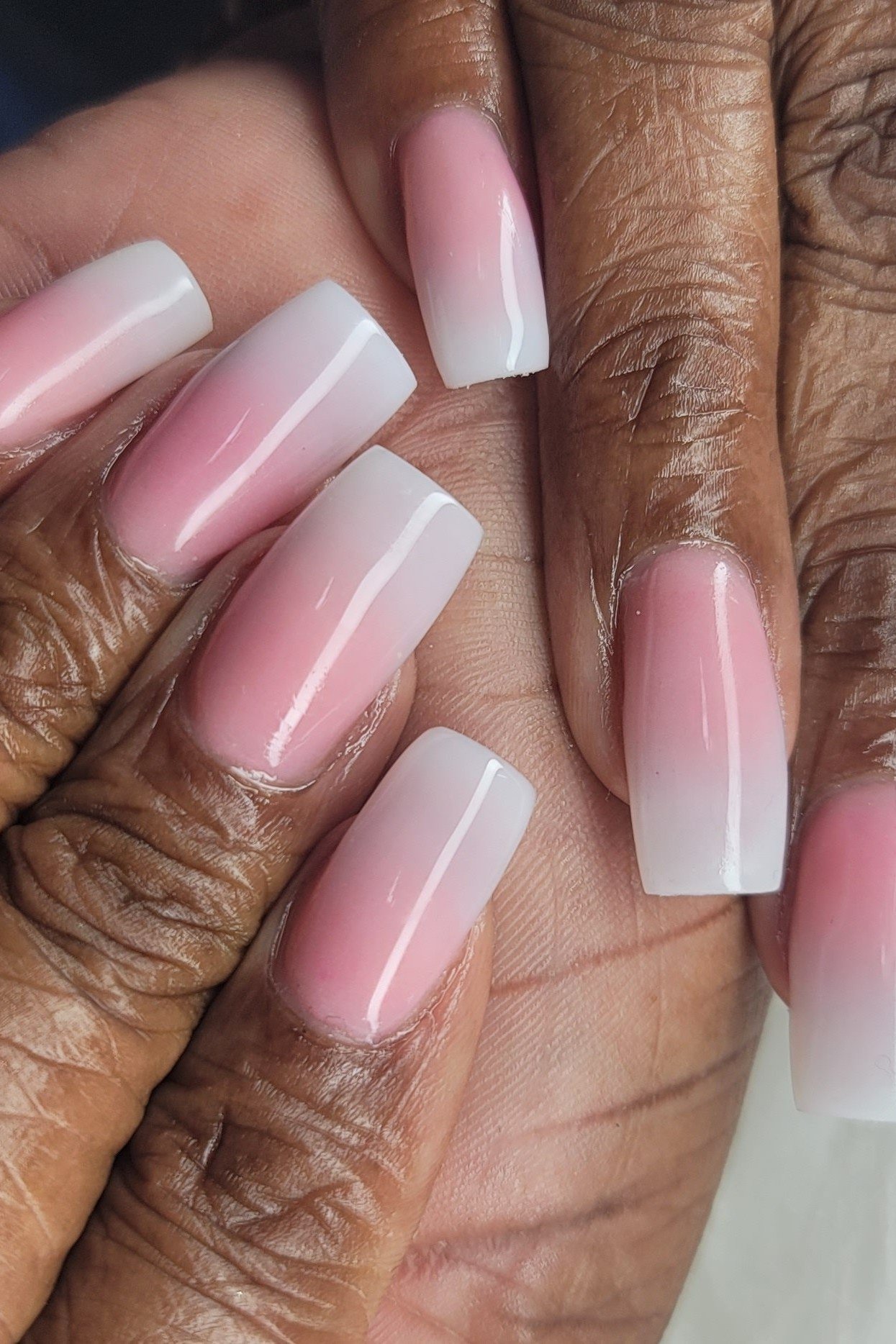 Pink ombre on mature darker skin hands, short nails, ombre nail design for women over 60