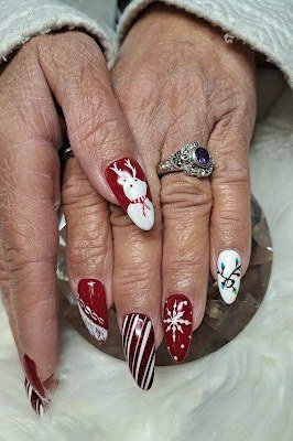 Elderly hands, deep red nails with white snowflake, stripe and polar bear accents - classy Christmas nail idea for women over 70