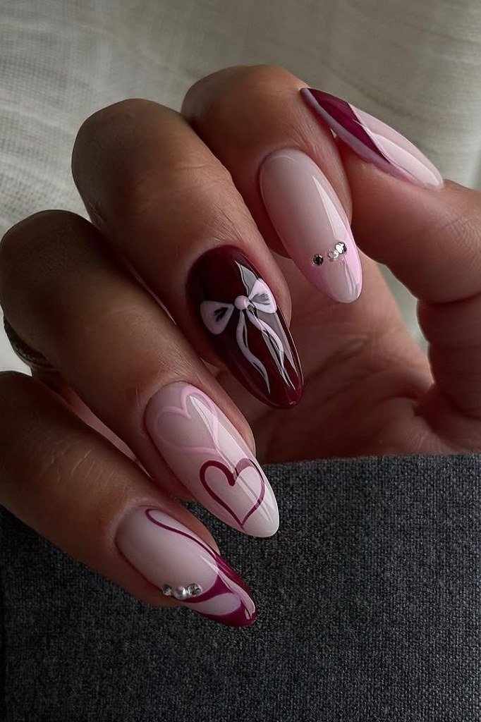 Burgundy Almond Nails with White Swirls and Hearts, fall nail color idea for women over 50
