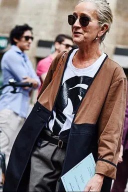 Elegant fall outfit for women over 70: brown vest with graphic tee