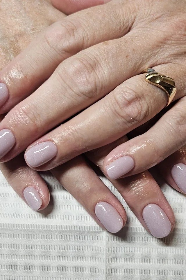 Soft lilac gel nails for women over 50