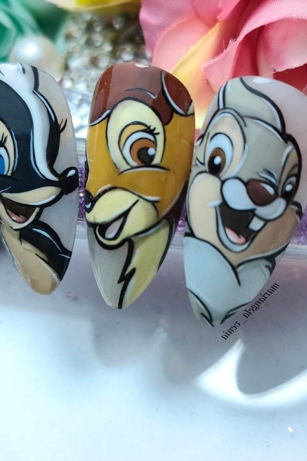 Almond nails with three hand-painted Bambi character faces fall nail art