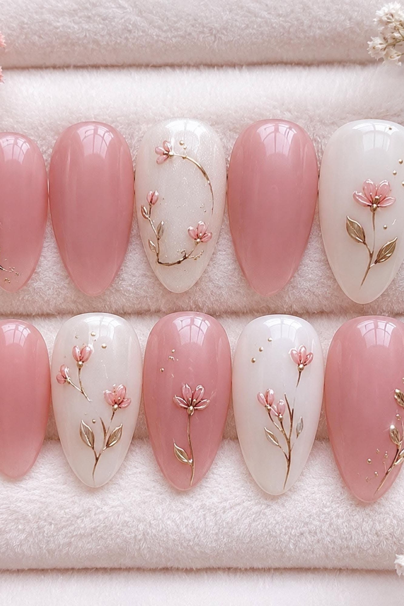 Pink and white press on nails with floral designs
