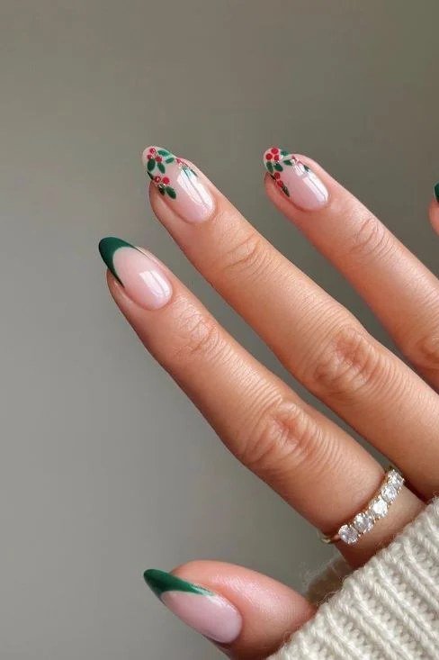 Nude base with emerald green french tips and tiny snowflake - Christmas nail design for older women
